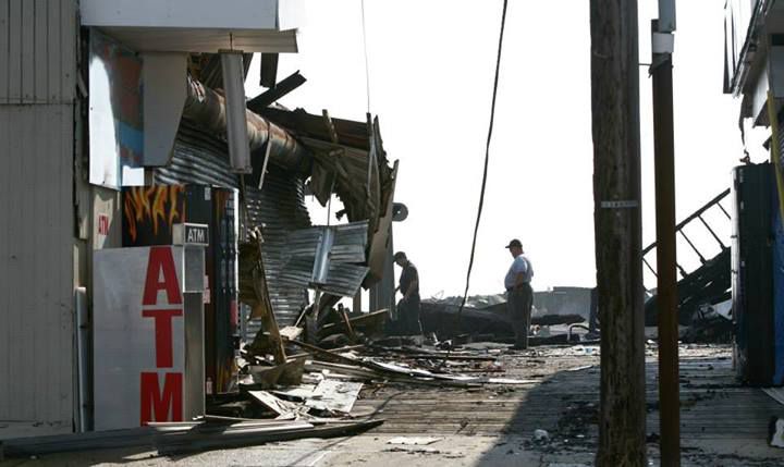 Fire fighters investigators look through the rubble before Governor Chris Christie holds a press conference